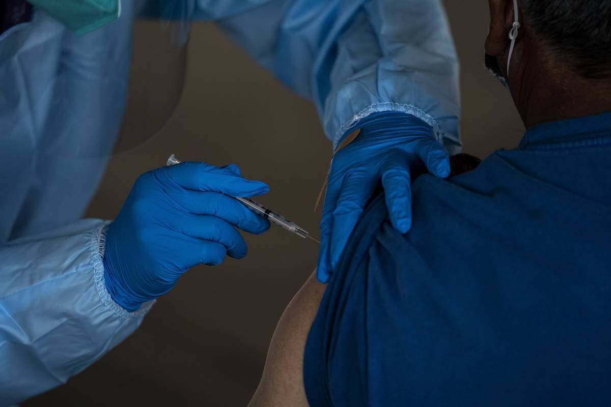 FILE - In this Jan. 21, 2021, file photo, a person receives the Pfizer-BioNTech COVID-19 vaccin ...