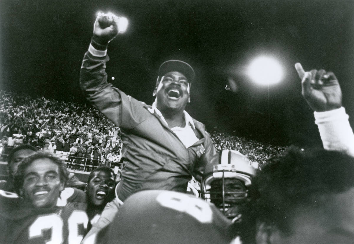 Coach Wayne Nunnely celebrates with his UNLV players after the Rebels beat Wisconsin 17-7 on Se ...