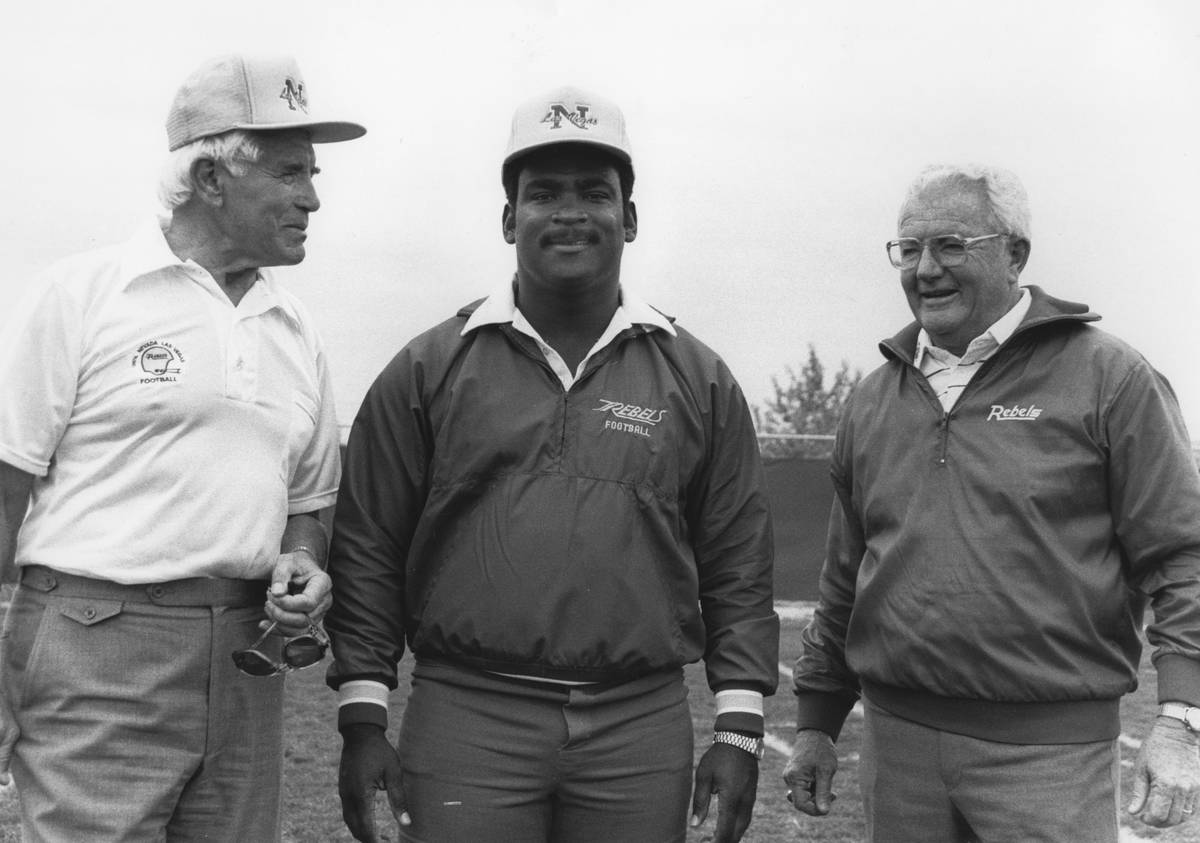 Wayne Nunnely stands before former UNLV head football coach Tony Knap (left) and Bill Ireland ( ...