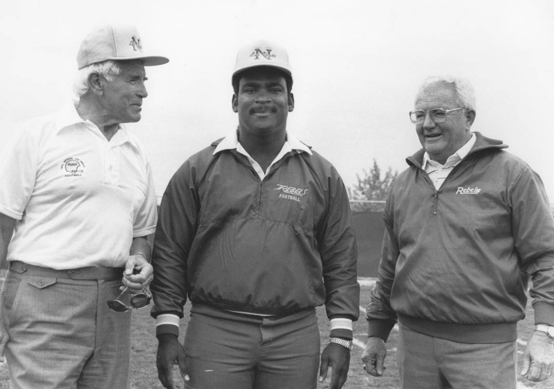 Wayne Nunnely stands before former UNLV head football coach Tony Knap (left) and Bill Ireland ( ...