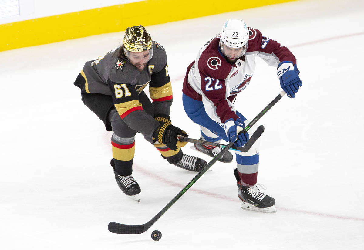 Golden Knights right wing Mark Stone (61) and Colorado Avalanche defenseman Conor Timmins (22) ...