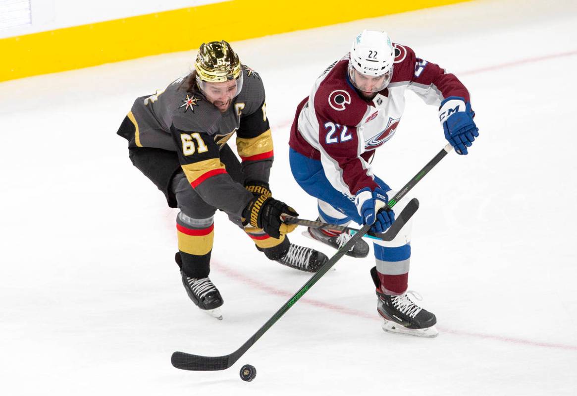 Golden Knights right wing Mark Stone (61) and Colorado Avalanche defenseman Conor Timmins (22) ...