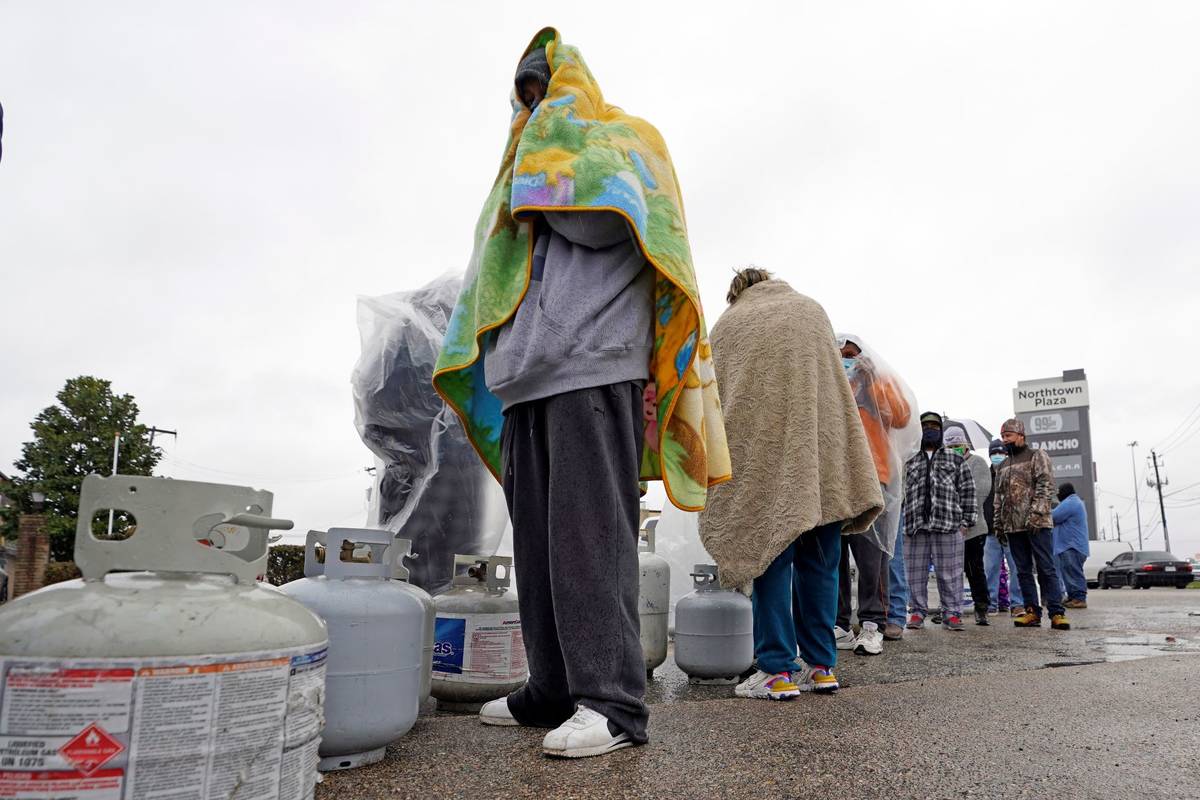 Carlos Mandez waits in line to fill his propane tanks Wednesday, Feb. 17, 2021, in Houston. (A ...