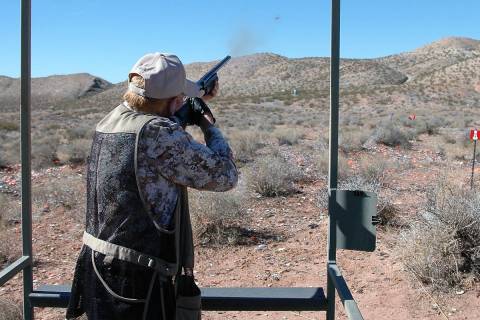 A shotgun enthusiast powders a clay target at his local shooting range. Recreational shooting, ...