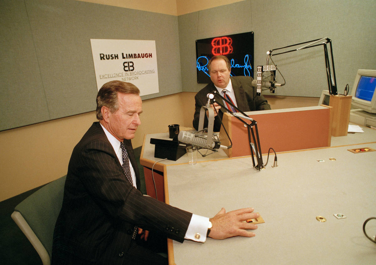 President George Bush talks with conservative radio host Rush Limbaugh at WABC studios in New Y ...