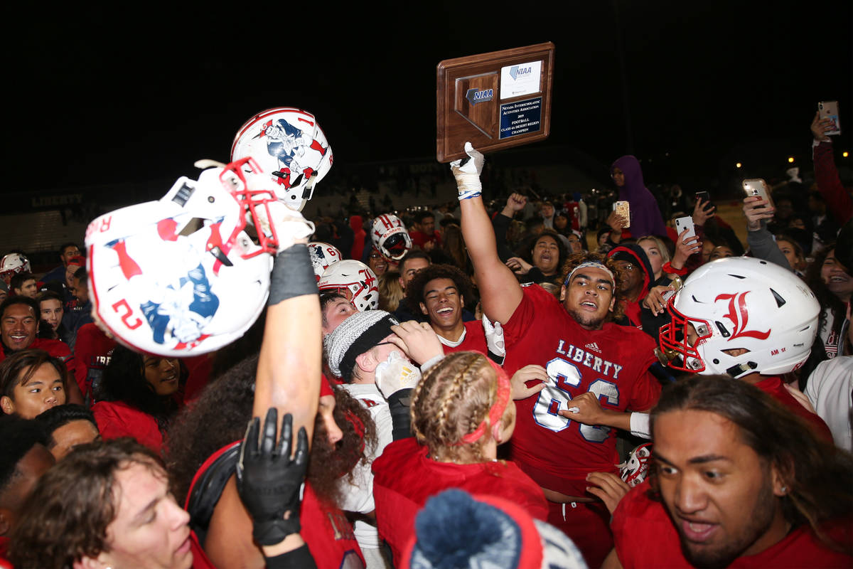 Liberty celebrates their 30-24 overtime win against Bishop Gorman in the football playoff game ...