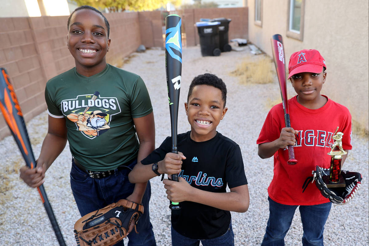 Brothers, from left, Marcel Aron Elzy, 13, Marlon Ray Elzy, 8, and Markez Lee Elzy, 9, at their ...