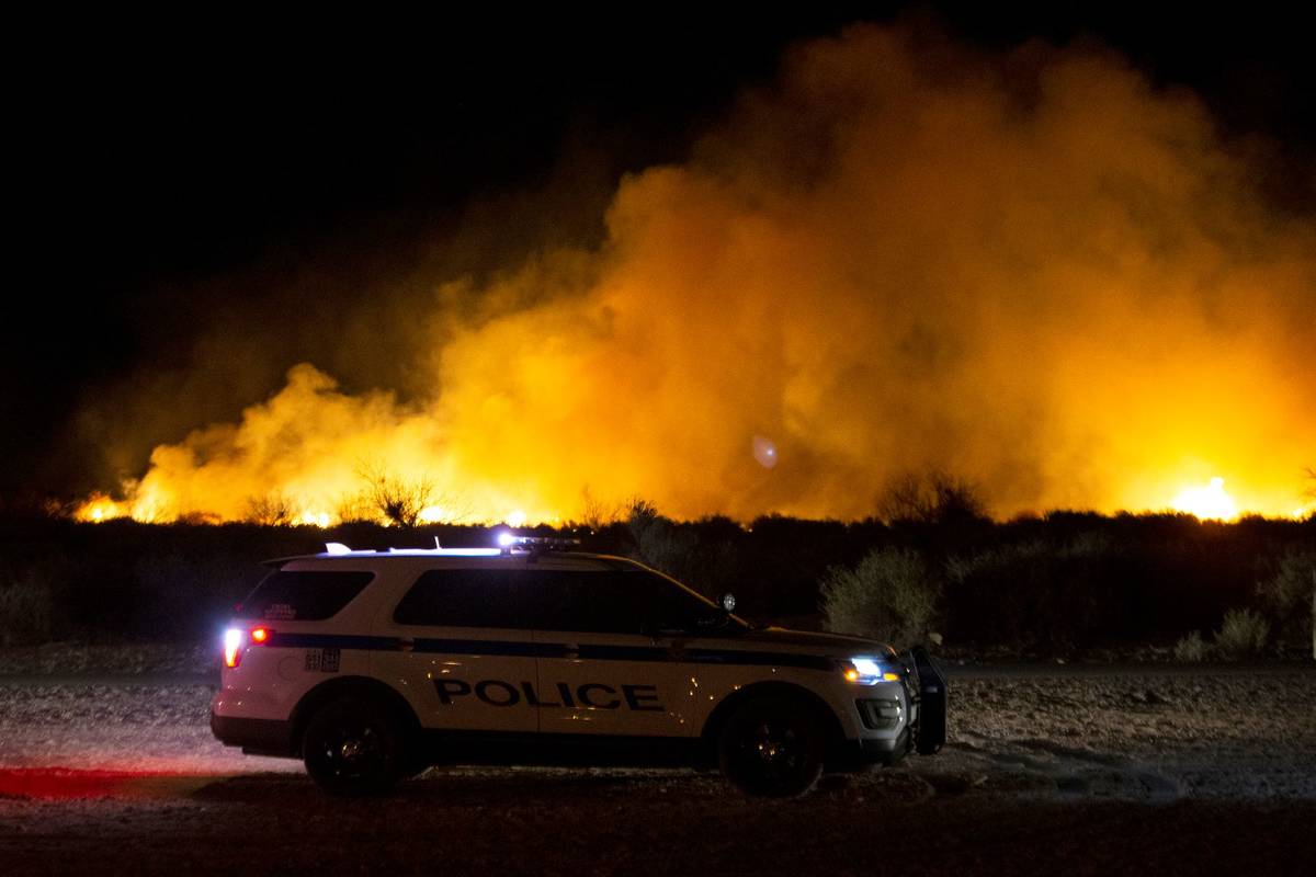 Henderson police are stationed near a brush fire burning at Clark County Wetlands Park on Wedne ...