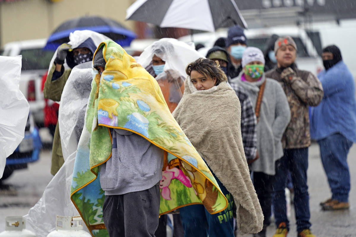 People wait in line to fill propane tanks Wednesday, Feb. 17, 2021, in Houston. (AP Photo/David ...