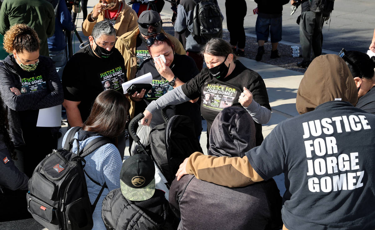 Carol Luke, right, says a prayer with loved ones of Jorge Gomez, a Black Lives Matter protester ...