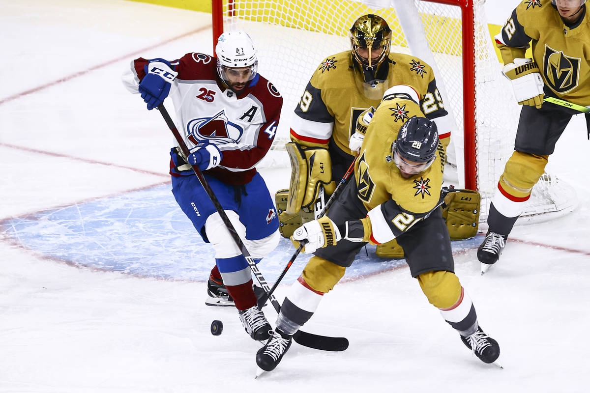 Golden Knights left wing William Carrier (28) sends the puck past former teammate Colorado Aval ...
