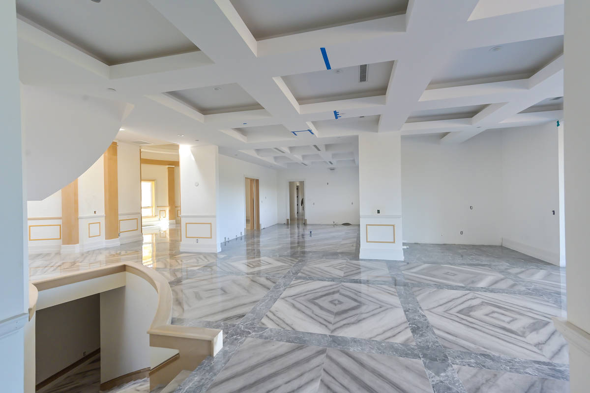 The home with a six-car garage has two main stories and a walk-out basement that has a poker ro ...