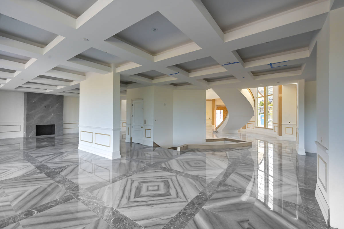 The home has a double staircase and fireplace in the center and looks dramatic when walking thr ...