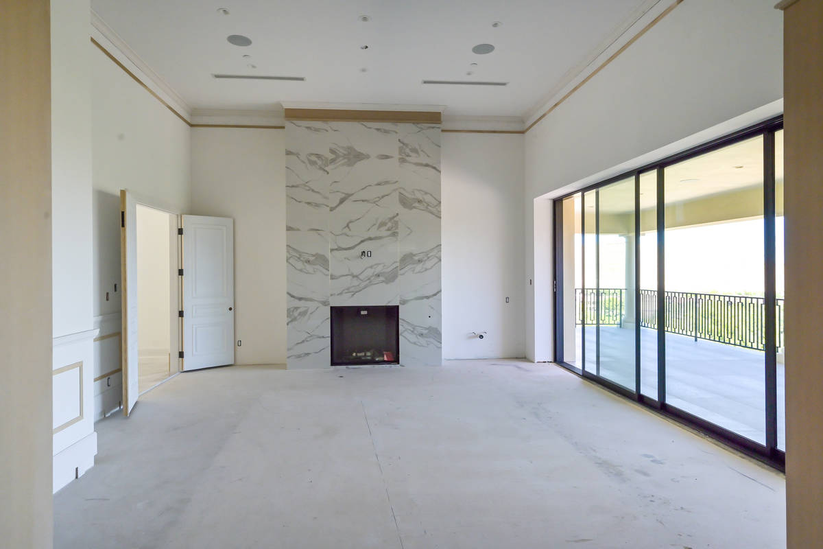 A fireplace is the center of the living room. (Luxurious Real Estate)
