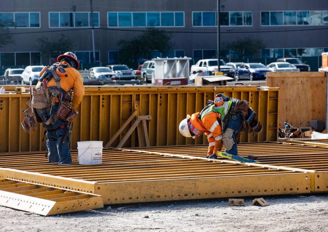 Construction workers work on the future medical education building for UNLV’s School of Medic ...