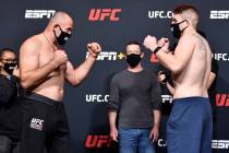 (L-R) Opponents Aleksei Oleinik of Russia and Chris Daukaus face off during the UFC weigh-in at ...