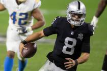 Raiders quarterback Marcus Mariota (8) scrambles past Los Angeles Chargers linebacker Uchenna N ...