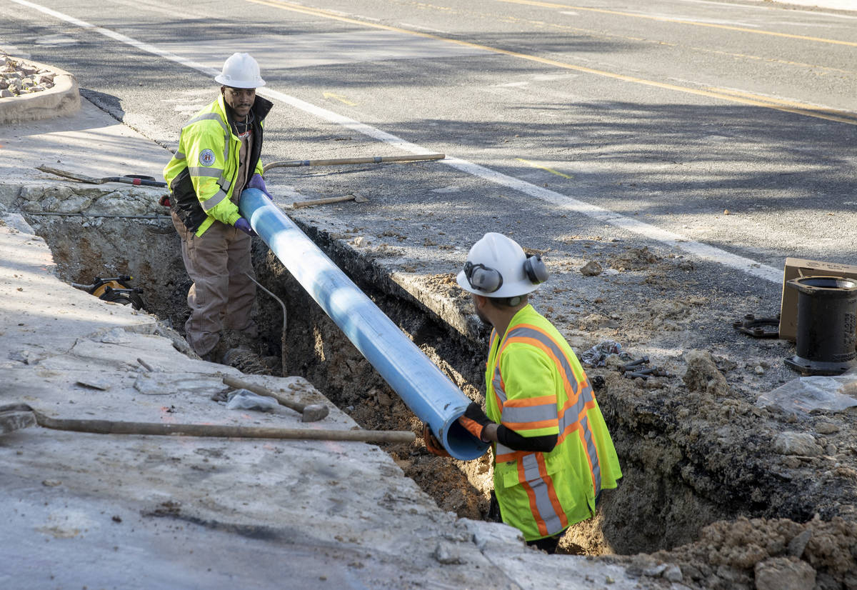 City of Austin Water Utility workers Joey Putman, left, and Salvador Tinajero repairs a broken ...