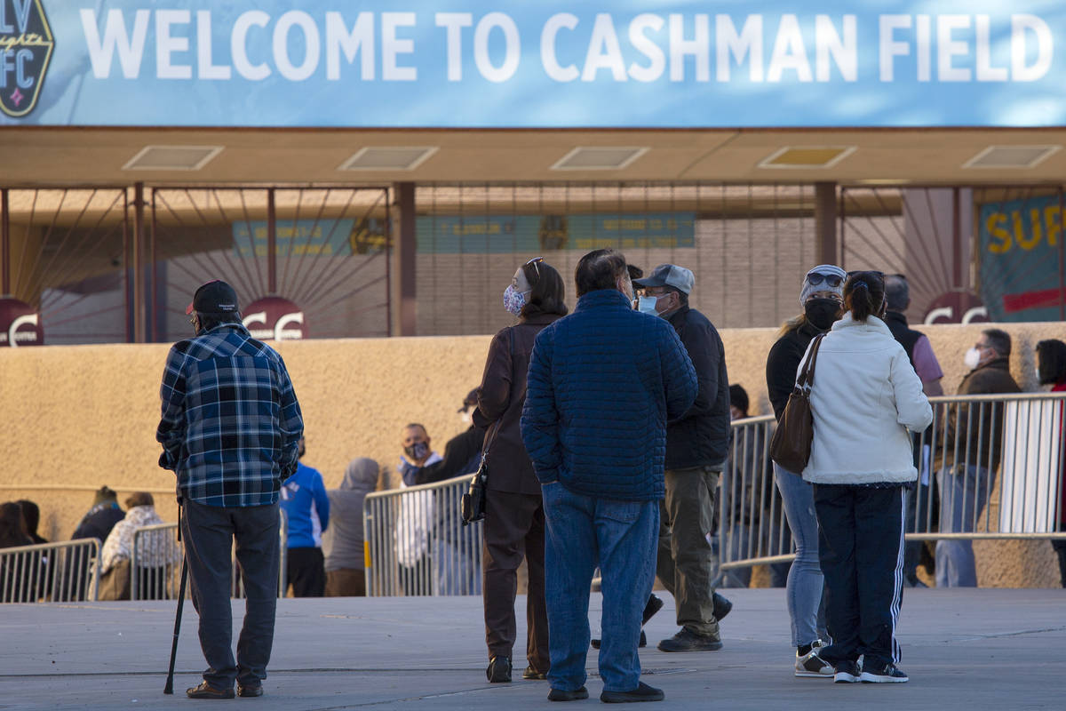 People wait in line for their COVID-19 vaccine at Cashman Field on Saturday, Feb. 20, 2021, in ...