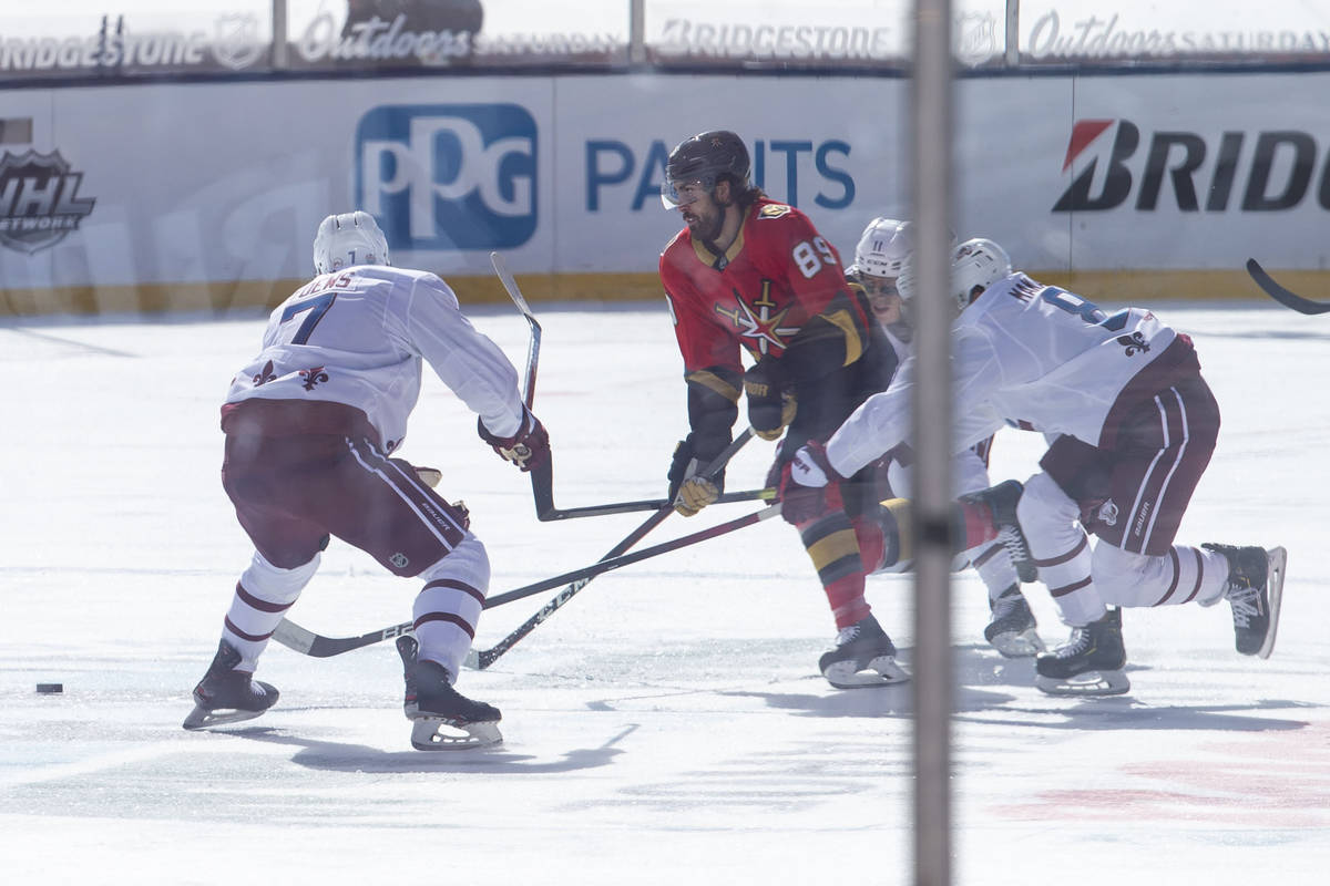 Vegas Golden Knights right wing Alex Tuch (89) controls the puck as Colorado Avalanche defensem ...