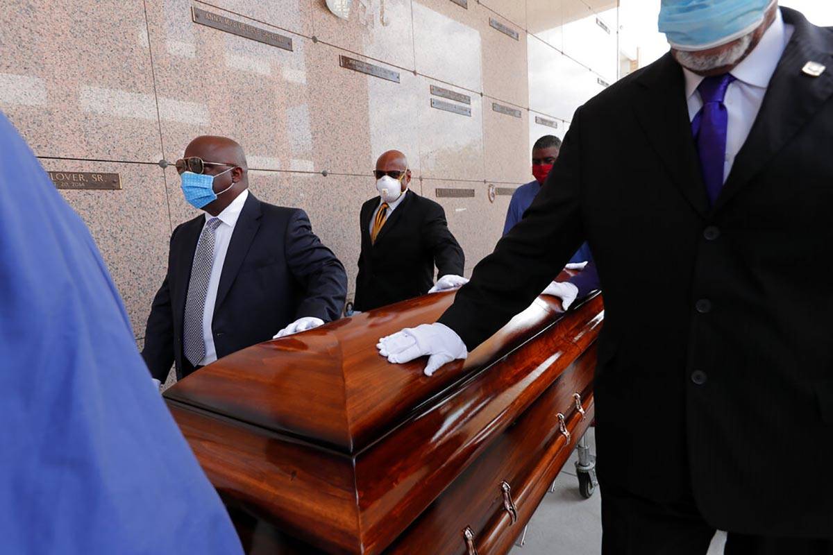 In this April 22, 2020, file photo, pallbearers, who were among only 10 allowed mourners, walk ...