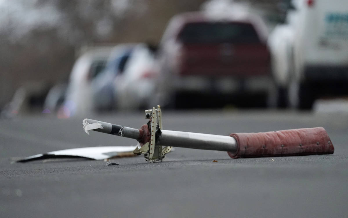 A part from a United Airlines jetliner sits in the middle of Elmwood Street in the street near ...