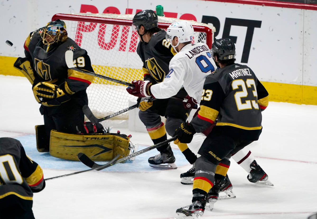 From left, Vegas Golden Knights goaltender Marc-Andre Fleury deflects a shot as defenseman Zach ...