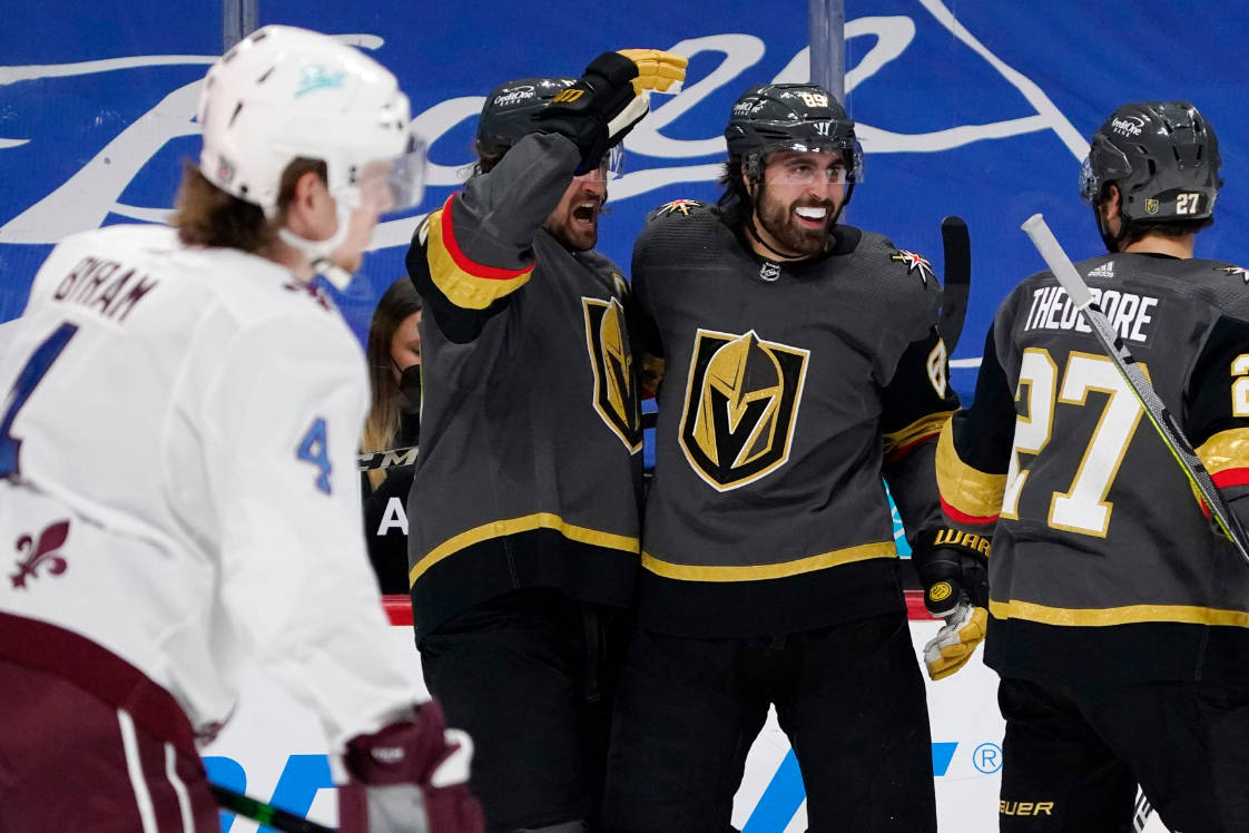 Vegas Golden Knights right wing Alex Tuch, back center, celebrates his goal with right wing Mar ...