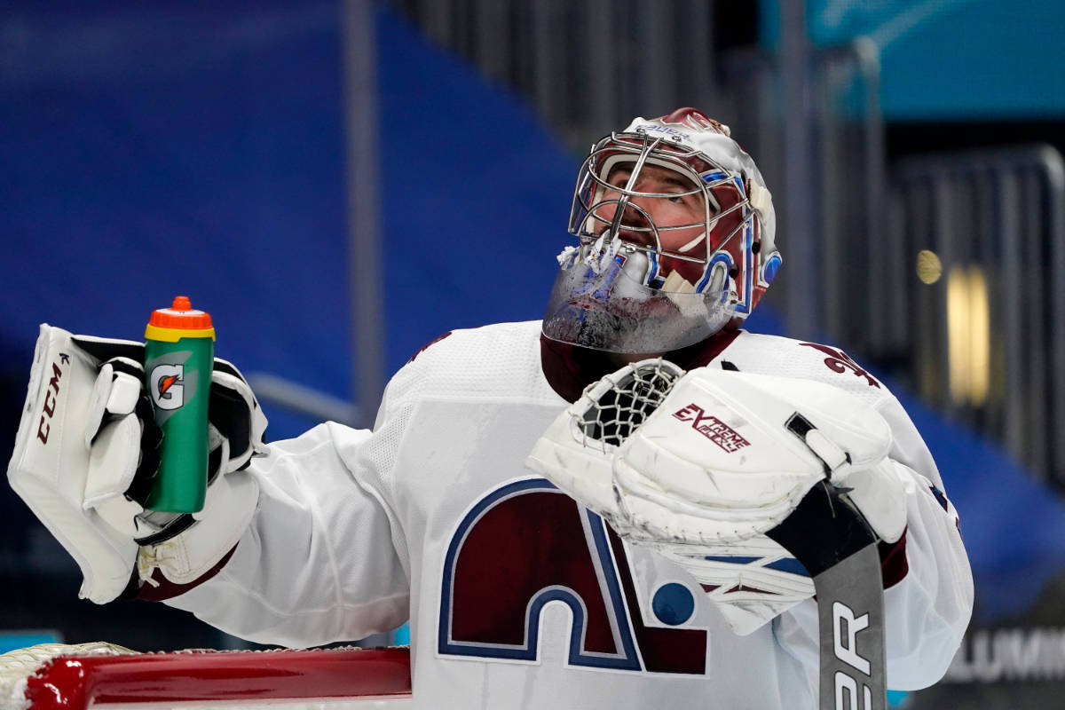 Colorado Avalanche goaltender Philipp Grubauer grabs his water bottle after giving up a goal to ...