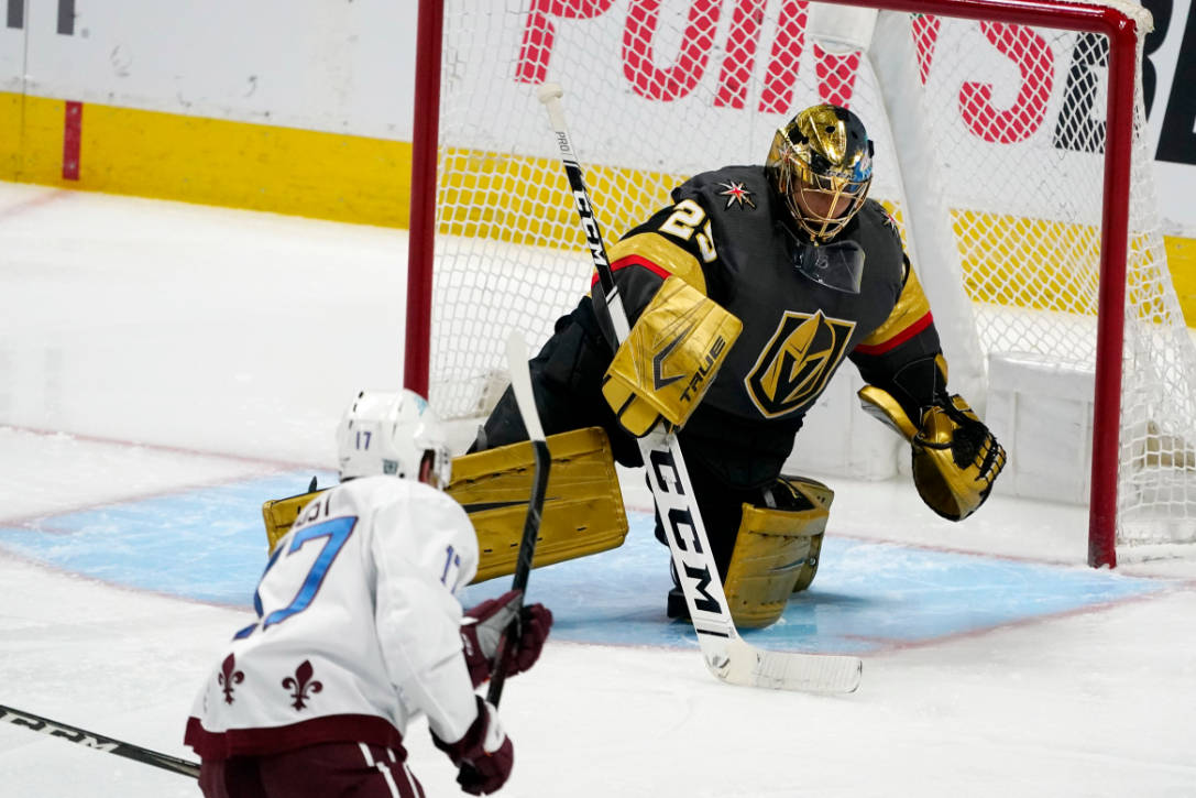 Vegas Golden Knights goaltender Marc-Andre Fleury, back, makes a stick save of a shot by Colora ...