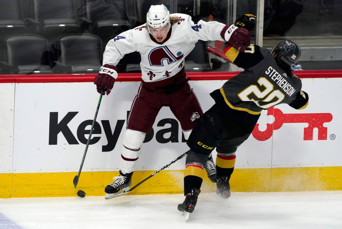 Colorado Avalanche defenseman Bowen Byram, left, fights for control of the puck with Vegas Gold ...