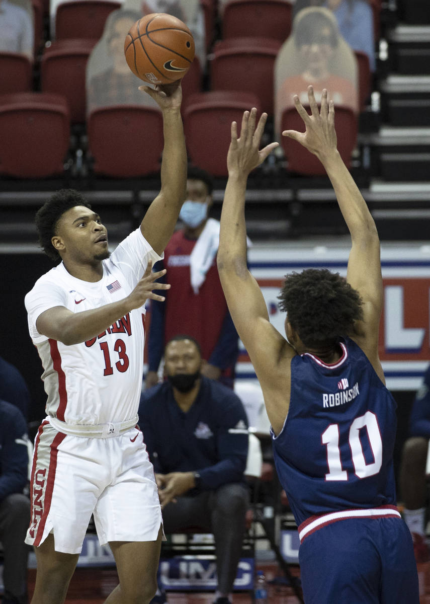 UNLV Rebels guard Bryce Hamilton (13) shoots over Fresno State Bulldogs forward Orlando Robinso ...