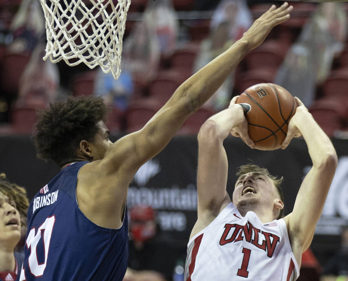 UNLV Rebels forward Moses Wood (1) drives past Fresno State Bulldogs forward Orlando Robinson ( ...