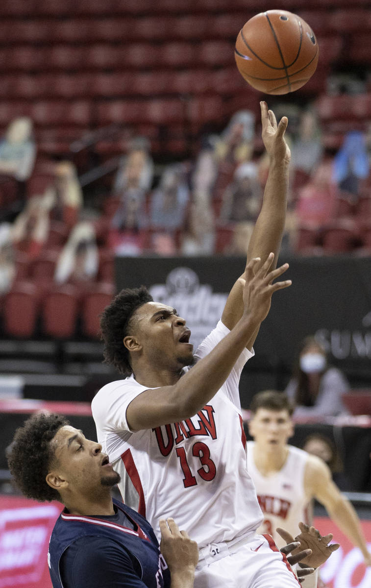 UNLV Rebels guard Bryce Hamilton (13) shoots over Fresno State Bulldogs guard Junior Ballard (4 ...