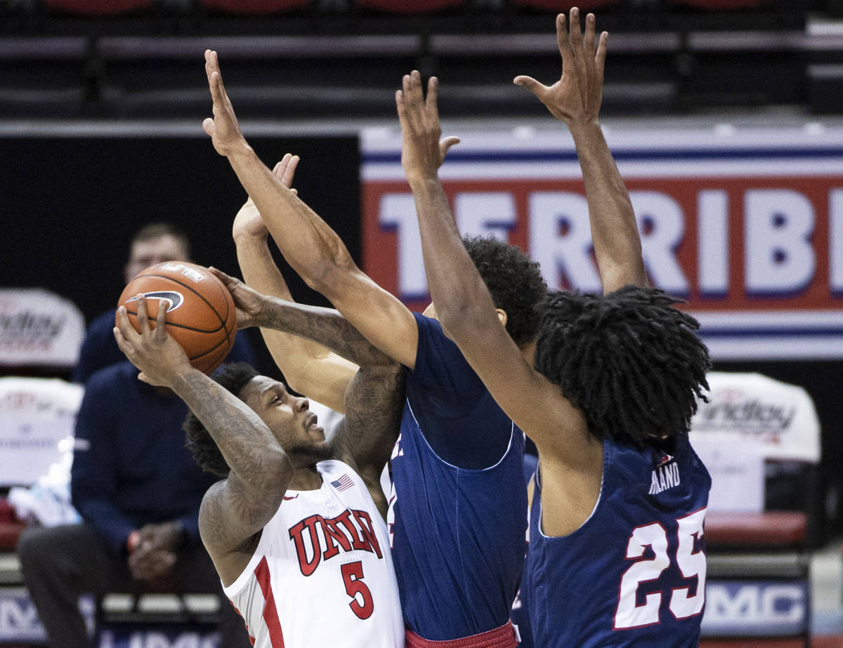 UNLV Rebels guard David Jenkins Jr. (5) shoots over Fresno State Bulldogs guard Junior Ballard ...