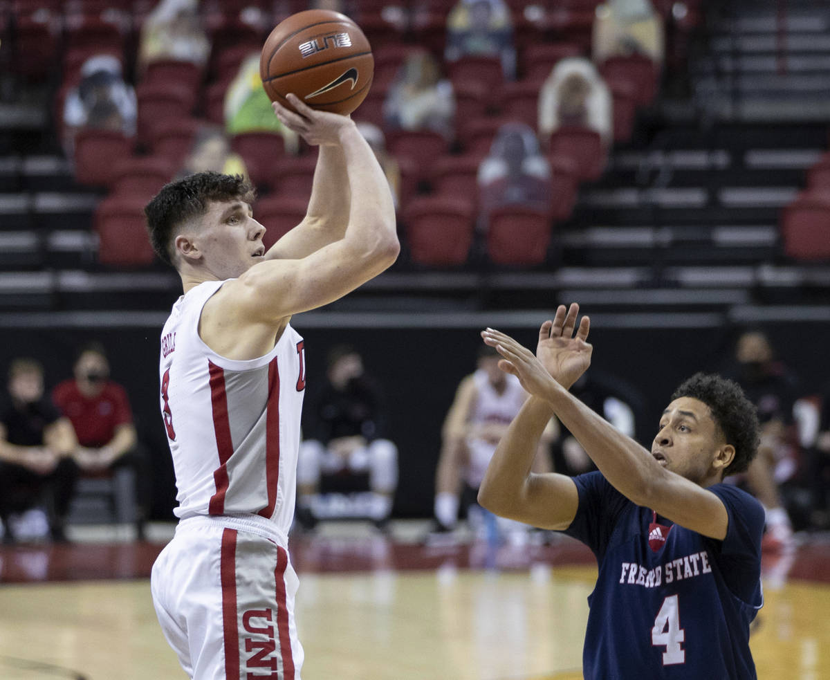 UNLV Rebels guard Caleb Grill (3) shoots over Fresno State Bulldogs guard Junior Ballard (4) in ...