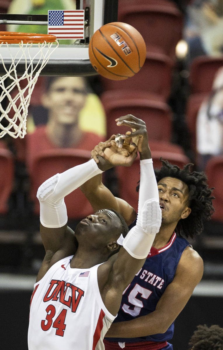 UNLV Rebels forward Cheikh Mbacke Diong (34) fights for a loose ball with Fresno State Bulldogs ...