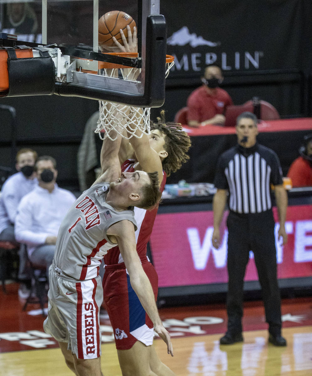 UNLV Rebels forward Moses Wood (1) gets inside of Fresno State Bulldogs guard Anthony Holland ( ...