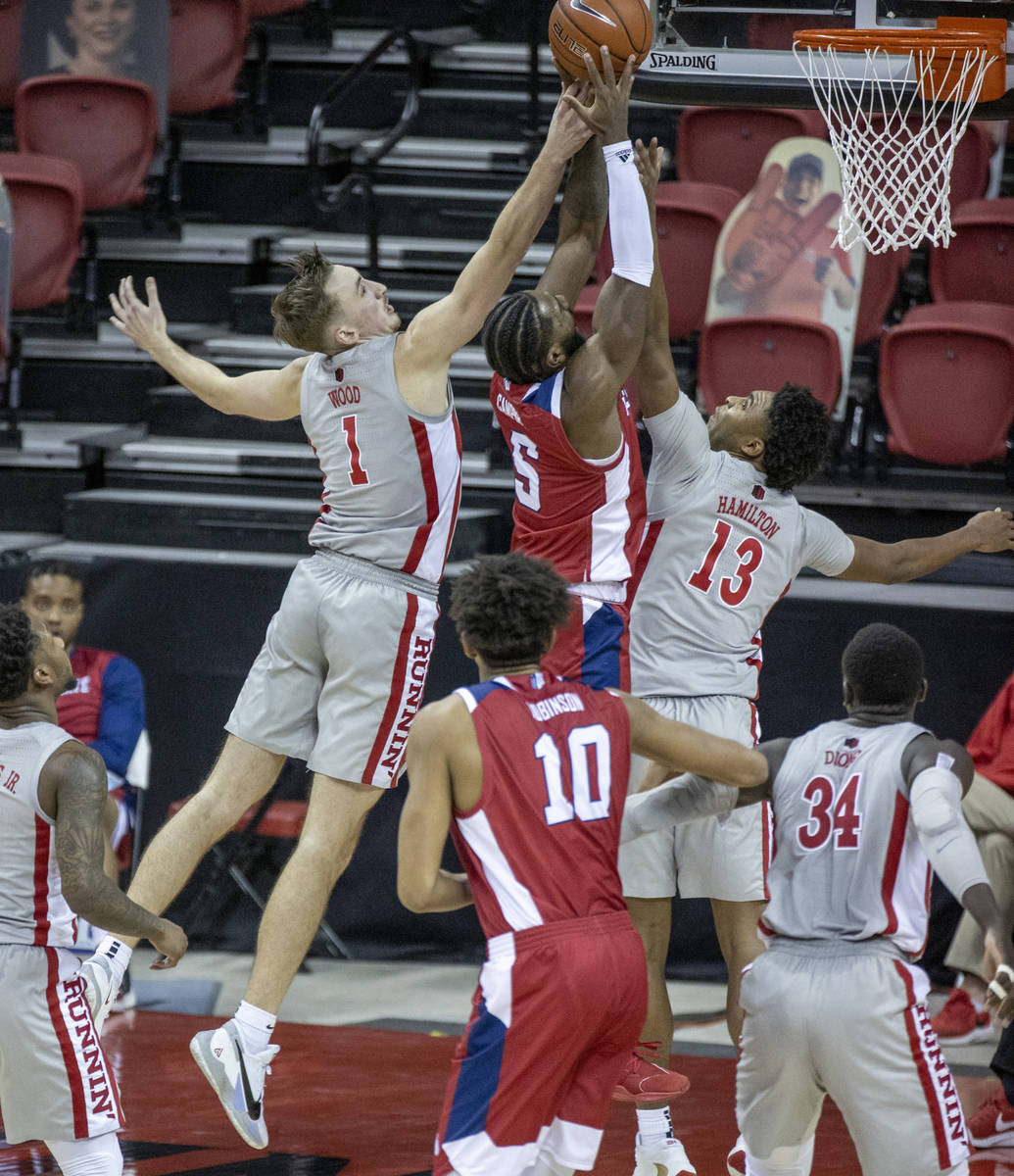 UNLV Rebels forward Moses Wood (1) and teammate guard Bryce Hamilton (13) double team Fresno St ...