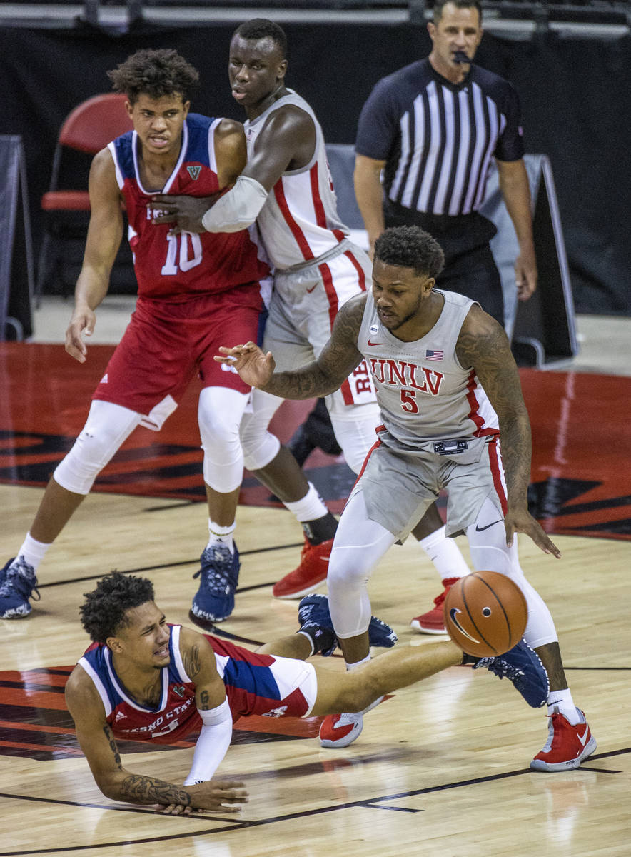 Fresno State Bulldogs guard Isaiah Hill (3) loses the ball while driving on UNLV Rebels guard D ...