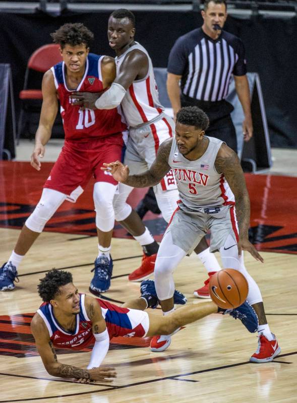 Fresno State Bulldogs guard Isaiah Hill (3) loses the ball while driving on UNLV Rebels guard D ...
