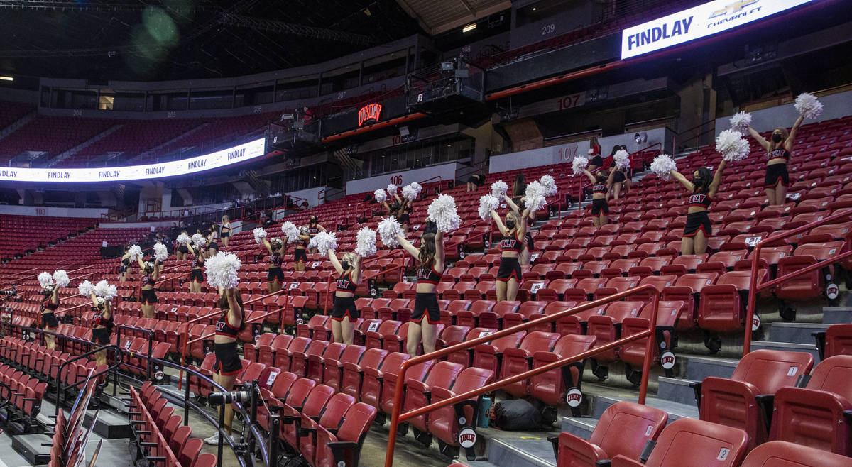 UNLV cheerleaders and spirit team pump up the players and 100 fans during the first half of an ...