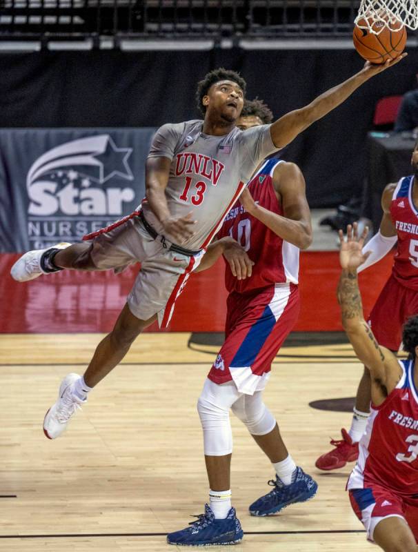 UNLV Rebels guard Bryce Hamilton (13) gets inside of Fresno State Bulldogs forward Orlando Robi ...