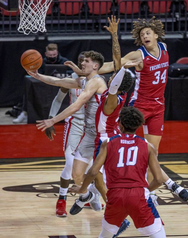 UNLV Rebels guard Caleb Grill (3) splits the Fresno State Bulldogs defense for a score during t ...