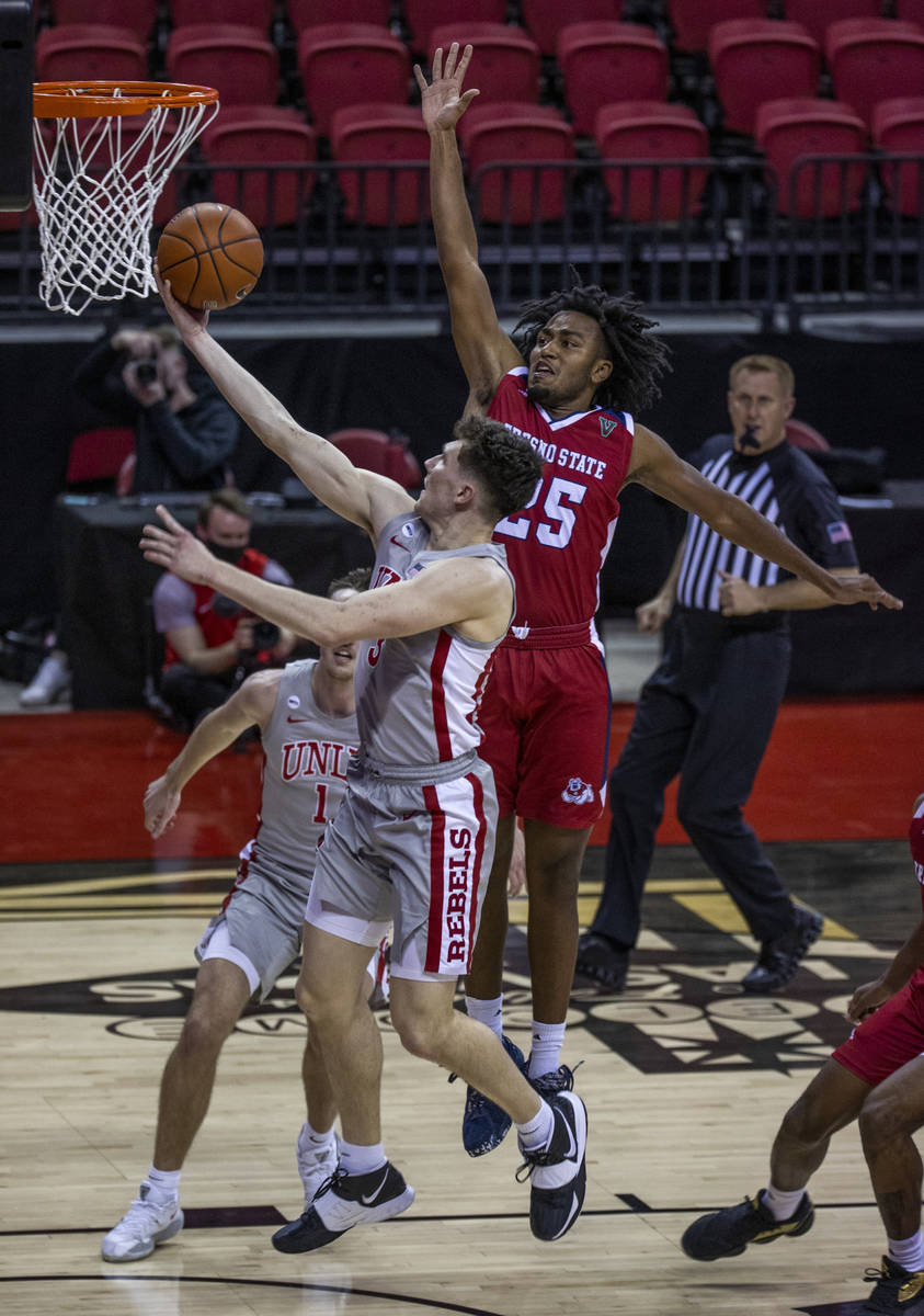 UNLV Rebels guard Caleb Grill (3) beats Fresno State Bulldogs guard Anthony Holland (25) to the ...