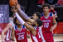 Fresno State Bulldogs guard Deon Stroud (13) and UNLV Rebels forward Devin Tillis (30) battle f ...