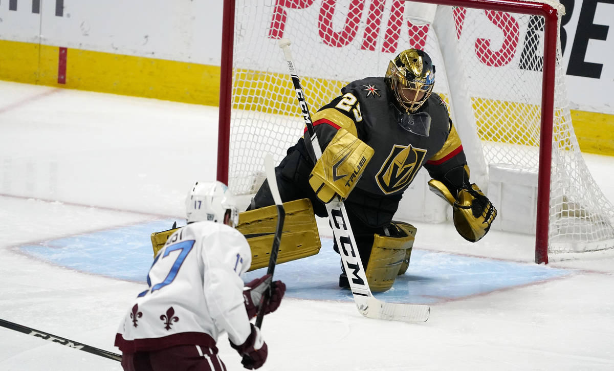 Vegas Golden Knights goaltender Marc-Andre Fleury, back, makes a stick save of a shot by Colora ...