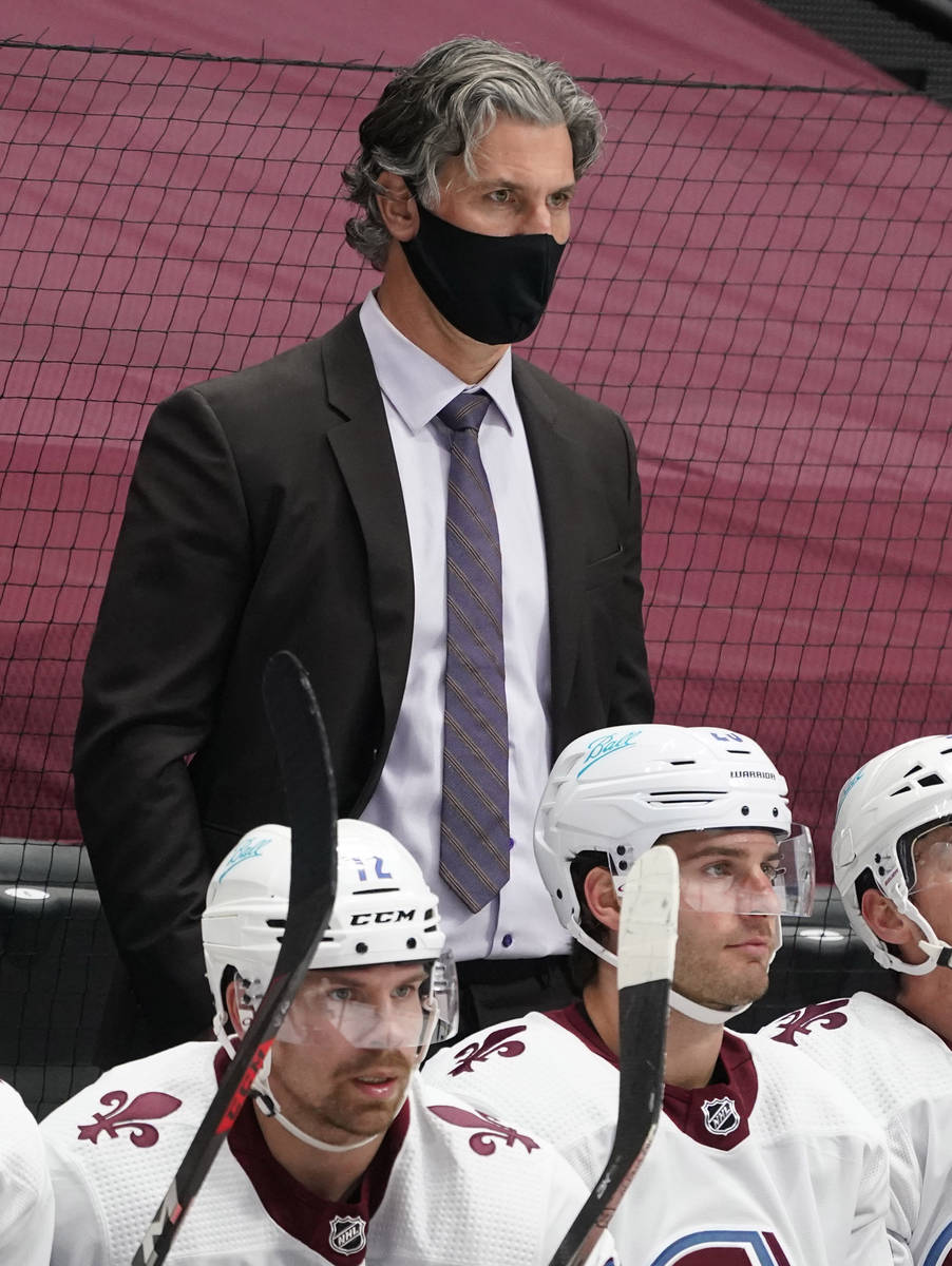 Colorado Avalanche head coach Jared Bednar, back, looks on in the third period of an NHL hockey ...