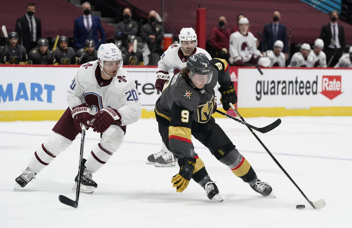 Vegas Golden Knights center Cody Glass, front right, picks up the puck as Colorado Avalanche le ...