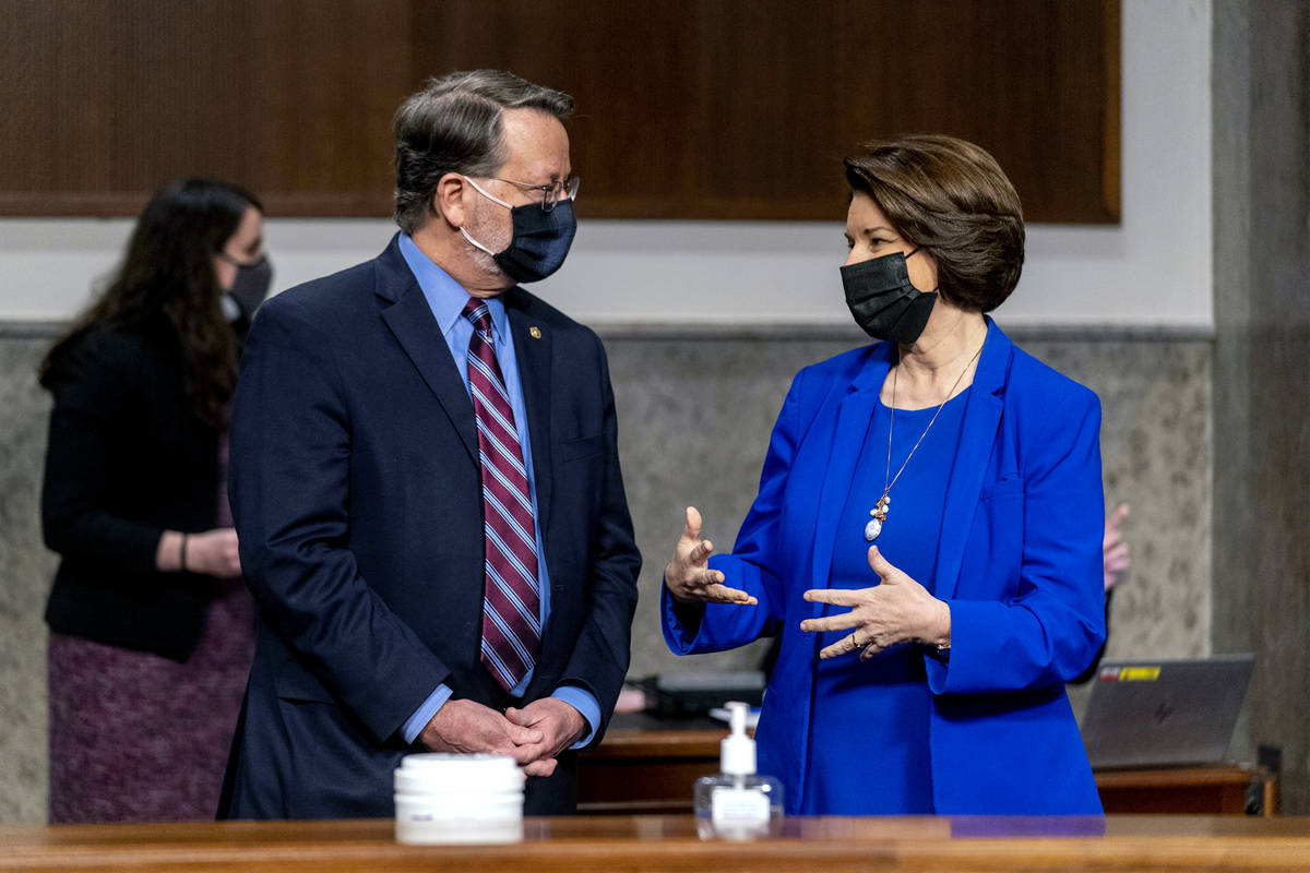 Chairman Sen. Gary Peters., D-Mich., left, and Chairwoman Amy Klobuchar, D-Minn., right, speak ...